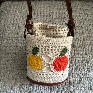 STAUD Cream Crochet Bucket Crossbody with Yellow and Red Fruit Motifs